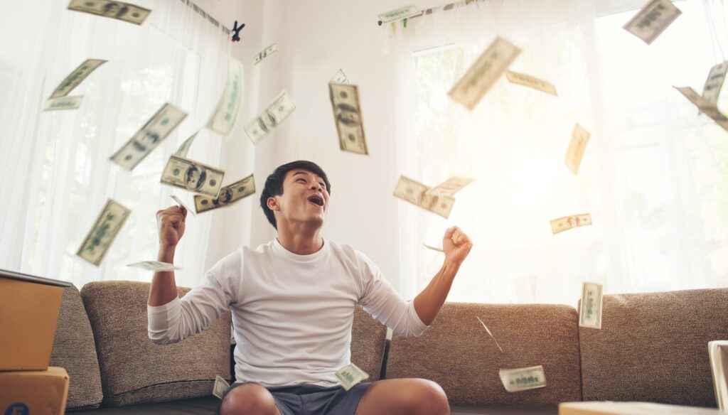 happy man with cash dollars flying home office rich from business online concept scaled